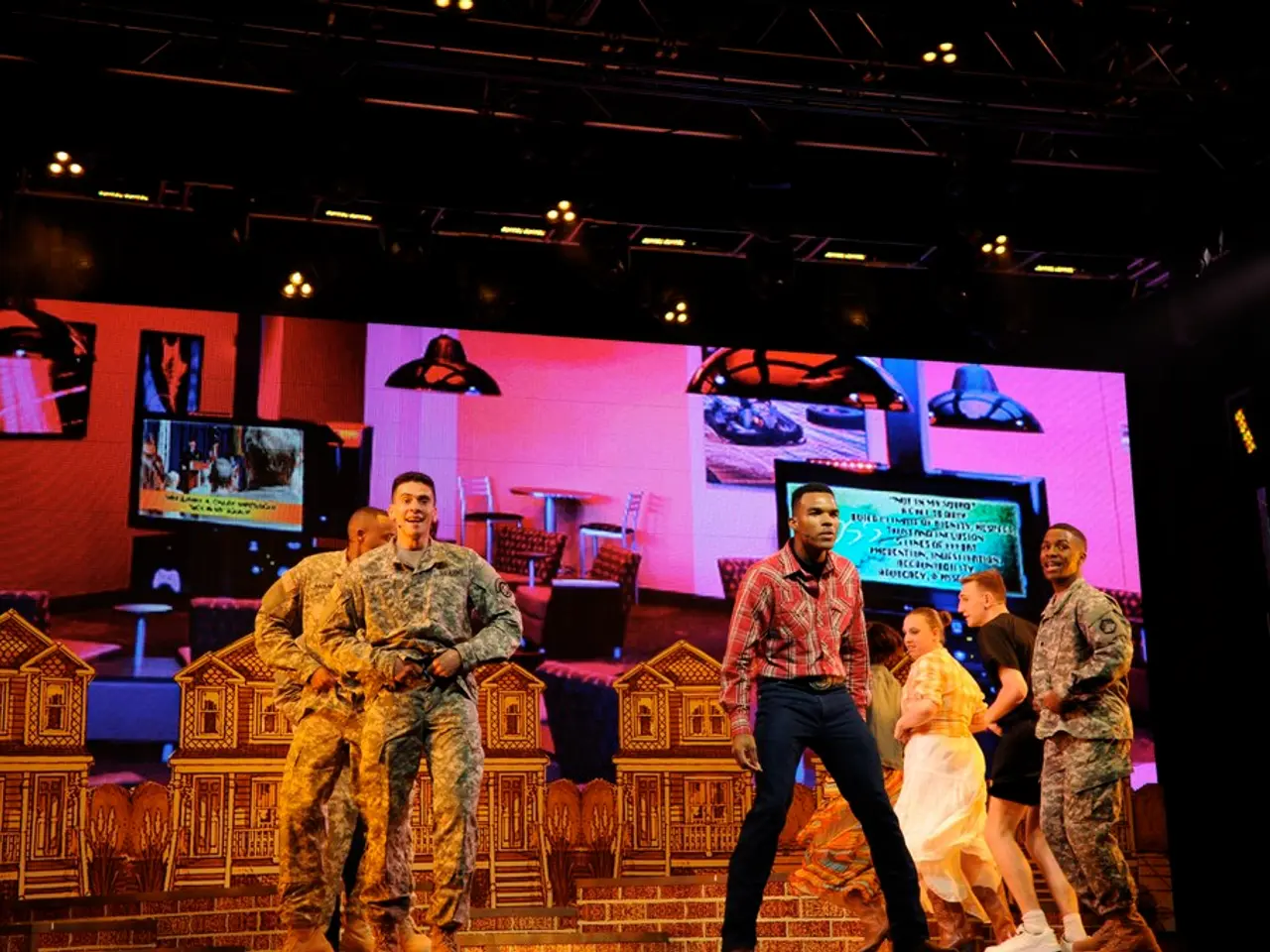 In this picture i can see a group of people among them few are wearing uniforms. In the background...