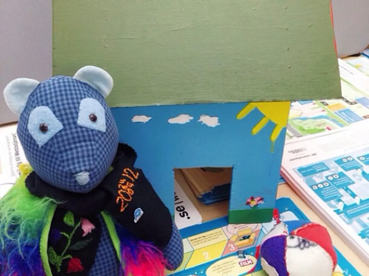 In this picture we can see toys and papers on the platform and in the background we can see card...